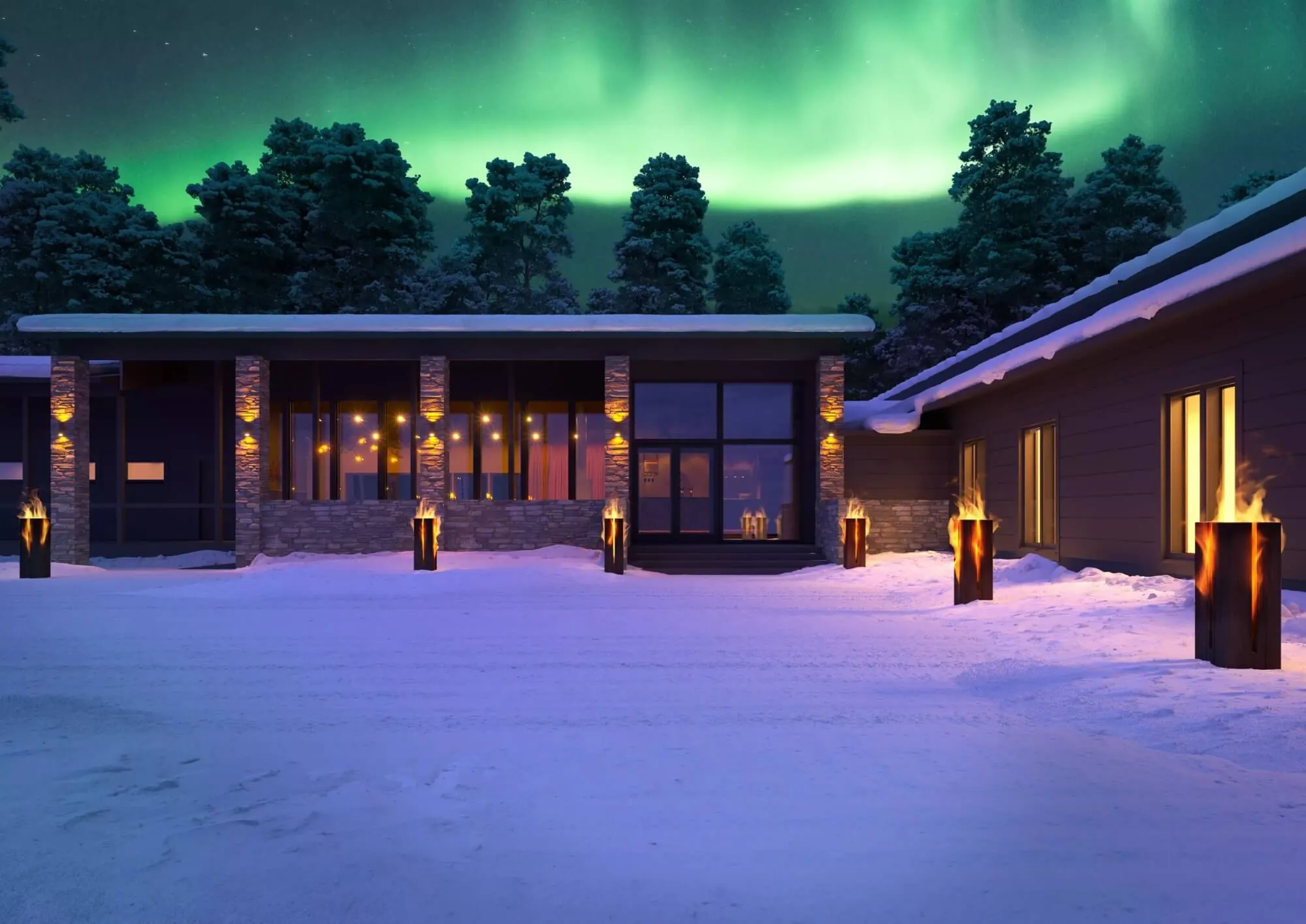 Hotel Kuura at night: a long low timber and stone building in snow, its full-height glazing lit warm from within, forest behind.